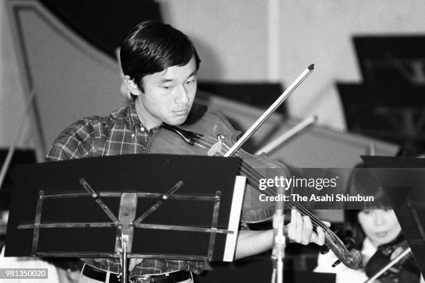 Prince Naruhito is seen during a practice session ahead of his viola solo performance at Aoyama Gakuin University on May 24, 1987 in Tokyo, Japan.