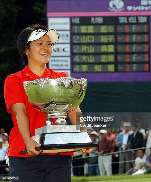 High school golfer Ai Miyazato poses for photographs after winning the Miyagi TV Cup Dunlop Ladies Open at Rifu Golf Club on September 28, 2003 in...