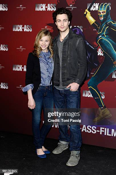 Actress Chloe Moretz and actor Aaron Johnson attend the photocall of 'Kick-Ass' at Soda Club at Kulturbrauerei on March 30, 2010 in Berlin, Germany.