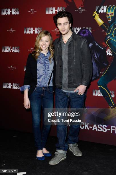 Actress Chloe Moretz and actor Aaron Johnson attend the photocall of 'Kick-Ass' at Soda Club at Kulturbrauerei on March 30, 2010 in Berlin, Germany.