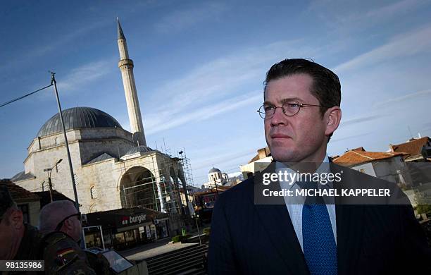 German Defence Minister Karl-Theodor zu Guttenberg looks on while speaking with Brigadier General Manfred Hofmeyer in the town of Prizren, southern...