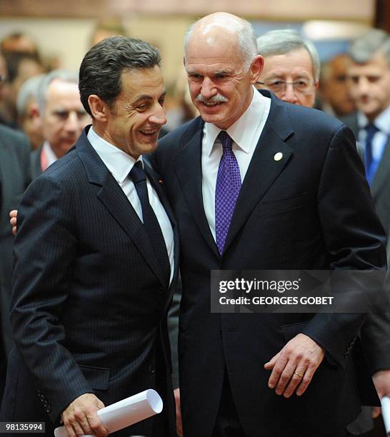 French President Nicolas Sarkozy and Greek Prime Minister George Papandreou arrive for a working session of an European Union summit at the European...