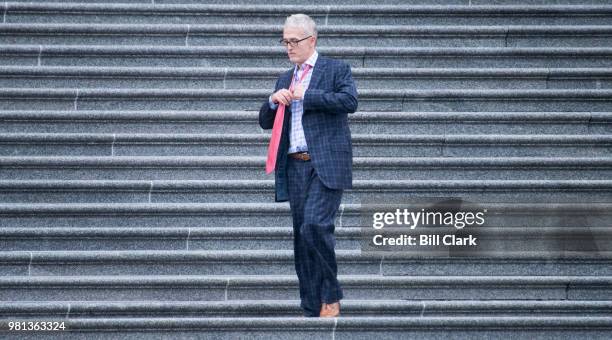 Rep. Trey Gowdy, R-S.C., takes off his tie as he walks down the House steps in the rain after the final vote of the week on Friday, June 22, 2018....