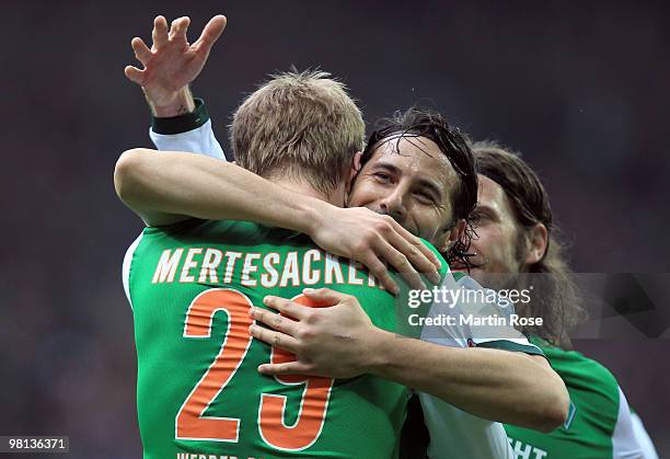 Per Mertesacker of Bremen celebrate with his team mates after he scores his team's opening goal during the Bundesliga match between Werder Bremen and...