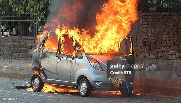 In this March 21, 2010 photograph, a brand new Tata Nano car, branded as the world's cheapest car, is seen engulfed in flames in the suburbs of...
