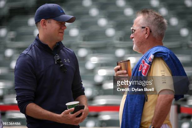 General manager Theo Epstein and manager Joe Maddon of the Chicago Cubs meet before the game against the Los Angeles Dodgers at Wrigley Field on June...