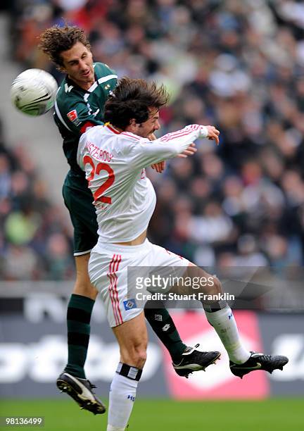 Ruud Van Nistelrooy of Hamburg is challenged by Marcel Meeuwis of Gladbach during the Bundesliga match between Borussia Moenchengladbach and...
