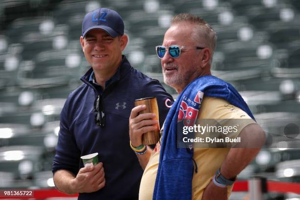 General manager Theo Epstein and manager Joe Maddon of the Chicago Cubs meet before the game against the Los Angeles Dodgers at Wrigley Field on June...