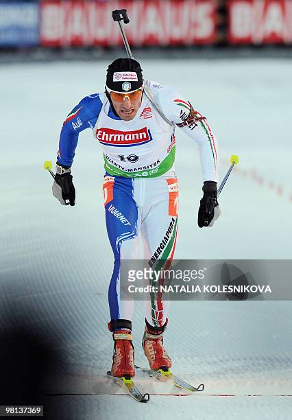 Christian de Lorenzi of Italy crosses the finish line in second place during the men's 10 km sprint event of the Biathlon World Cup in the Siberian...