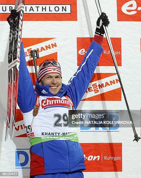 Russia's Ivan Tcherezov celebrates his first place on the podium after the men's 10 km sprint event of the Biathlon World Cup in the Siberian city of...