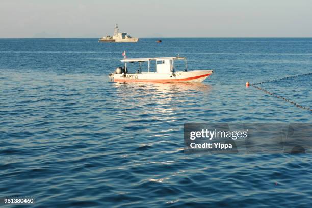 boats on a tropical beach - mabul island stock pictures, royalty-free photos & images