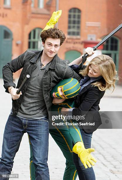 Actor Aaron Johnson, superhero character and actress Chloe Moretz attend the photocall of 'Kick-Ass' at Kulturbrauerei on March 30, 2010 in Berlin,...