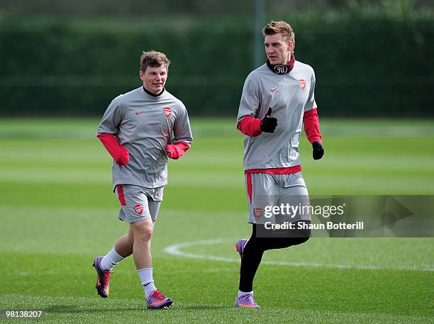 Andrey Arshavin of Arsenal warms-up with team-mate Nicklas Bendtner during Arsenal training ahead of their UEFA Champions League quarter final first...