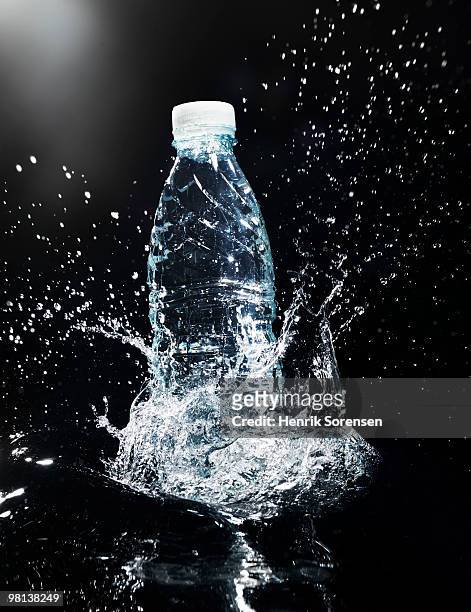 water bottle in splashing water - water bottle splash stock pictures, royalty-free photos & images