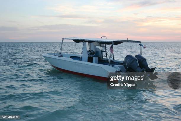 speed boat on a tropical beach - mabul island stock pictures, royalty-free photos & images