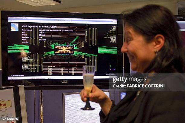 An European Organization for Nuclear Research scientist cheers after the first ultra high-energy collisions at the CMS experiment control room on...