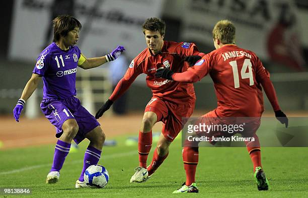 Hisato Sato of Sanfrecce Hiroshima and Michael Marrone of Adelaide United compete for the ball during the AFC Champions League Group H match between...