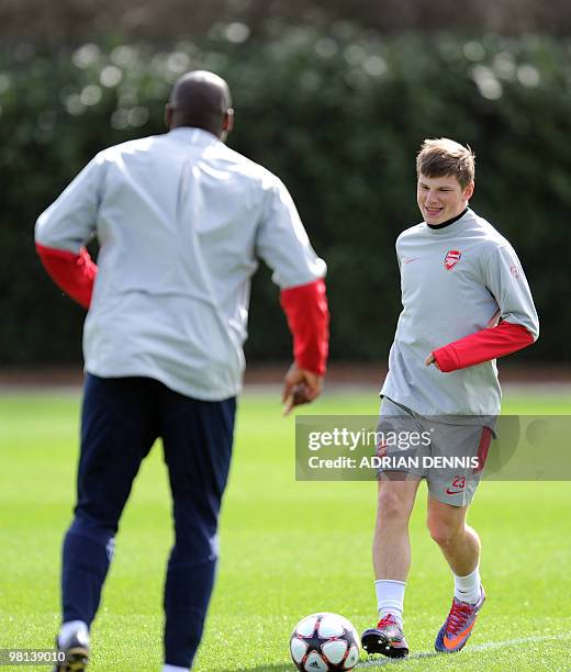 Arsenal's Russian midfielder Andrey Arshavin runs toward veteran defender Sol Campbell during a training session at the club's complex in London...