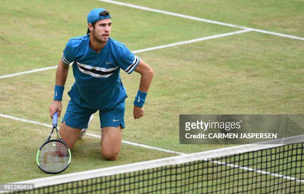 Karen Khachanov from Russia knees during his match against Roberto Bautista Agut from Spain at the ATP Gerry Weber Open tennis tournament in Halle,...