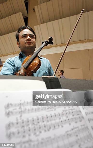 Venezuelan violonist Alexis Cardenas rehearses with the Ile de France national orchestra, on March 30 in Alfortville, outside Paris. Cardenas makes...