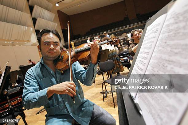 Venezuelan violonist Alexis Cardenas rehearses with the Ile de France national orchestra, on March 30 in Alfortville, outside Paris. Cardenas makes...