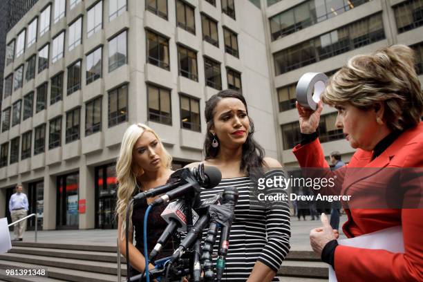 Former Houston Texans cheerleaders Hannah Turnbow and Angelina Rose look on as attorney Gloria Allred holds up a roll of duct tape during a press...