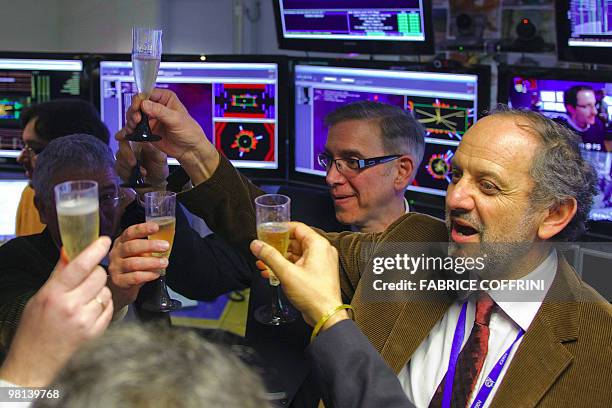 European Organization for Nuclear Research scientists celebrate with champagne reacts after the first ultra high-energy collisions at the CMS...