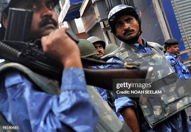 Indian Rapid Action Force personnel patrol after an outbreak of communal violence at Nalla Gutta in Hyderabad on March 30, 2010. Indian police have...