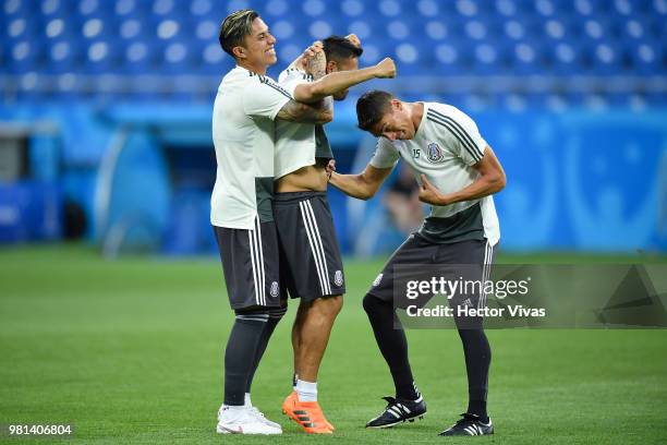 Carlos Salcedo, Marco Fabian and Hector Moreno of Mexico have fun during a training and press conference ahead of the match against Korea as part of...