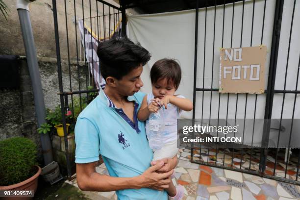 Man -who had been arrested in recent protests- holds a baby after being released from jail in Masaya, Nicaragua on June 22, 2018. - Ten people were...