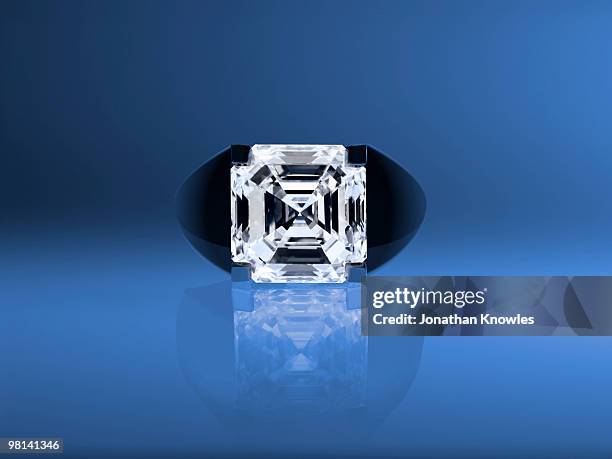 diamond ring on a blue background - gemology stock-fotos und bilder