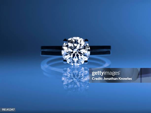 diamond ring on a blue background - diamantring stock-fotos und bilder