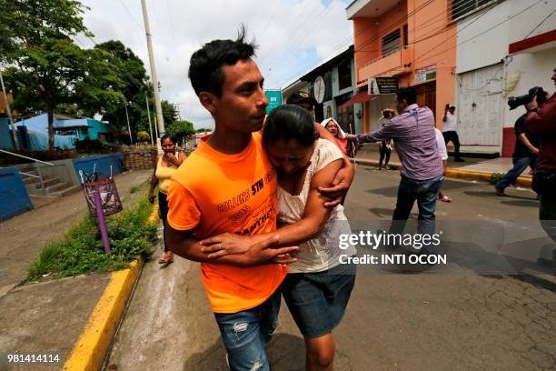 Man -who had been arrested in recent protests- embraces a relative as he walks after being released from jail in Masaya, Nicaragua on June 22, 2018....