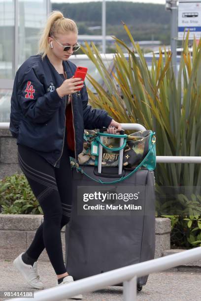 Sophie Turner arriving at Aberdeen Airport facetiming Joe Jonas before the wedding of Kit Harrington and Rose Leslie on June 22, 2018 in Aberdeen,...