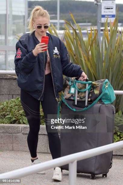 Sophie Turner arriving at Aberdeen Airport facetiming Joe Jonas before the wedding of Kit Harrington and Rose Leslie on June 22, 2018 in Aberdeen,...