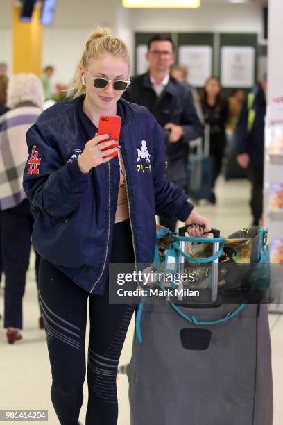 Sophie Turner arriving at Aberdeen Airport facetiming Joe Jonas before the wedding of Kit Harrington and Rose Leslie on June 22, 2018 in Aberdeen,...