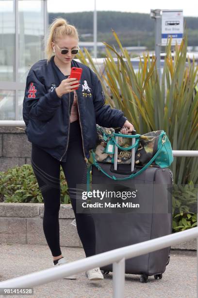 Sophie Turner arriving at Aberdeen Airport facetiming Joe Jonas before the wedding of Kit Harrington and Rose Leslie on June 22, 2018 in Aberdeen,...