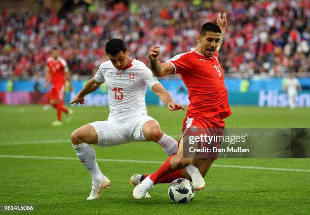 Aleksandar Mitrovic of Serbia is tackled by Blerim Dzemaili of Switzerland during the 2018 FIFA World Cup Russia group E match between Serbia and...
