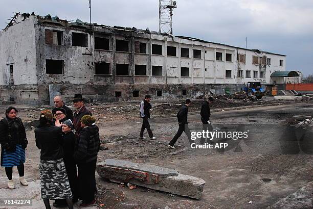 Local Ingush people have a conversation in Nazran on March 30, 2010 while standing near the remains of the police compound that was attacked on...