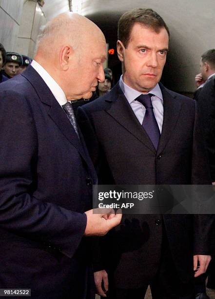 Russian President Dmitry Medvedev and Moscow Mayor Yuri Luzhkov speak as they inspect the site of the blast at the Lubyanka metro station in Moscow...