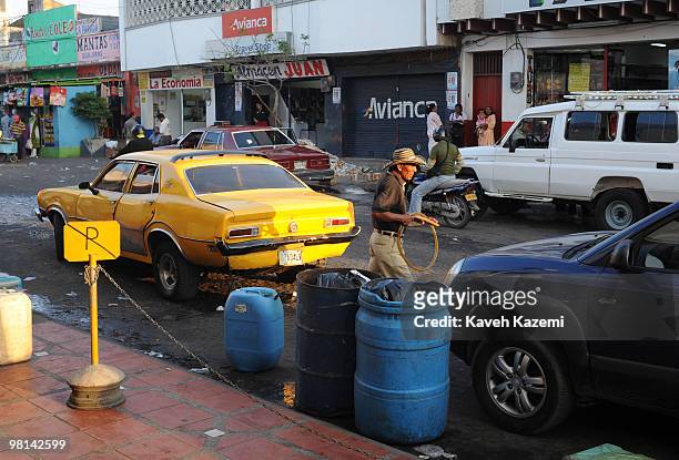 Man sells cheap petrol from Venezuela that is made readily available from the other side of border. Maicao is a city and municipality in the...