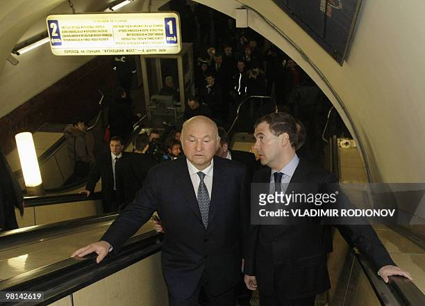 Russian President Dmitry Medvedev and Moscow Mayor Yuri Luzhkov ride an escalotor while visiting the site of a terrorist blast at the Lubyanka metro...