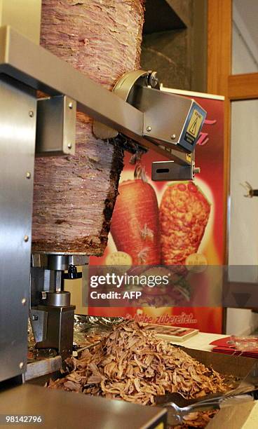 The new doner kebab-cutting robot slices kebab meat during the "Doga" doner gastronomy trade fair in Berlin on March 27, 2010. Doner kebab-cutting...