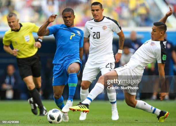 Douglas Costa of the Brazil national football team and David Guzman, Oscar Duarte of the Costa Rica national football team vie for the ball during...