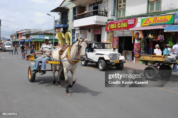 Man rides on an old fashioned cart in the main square. Quimbaya is a town and municipality in the western part of the department of Quindío,...
