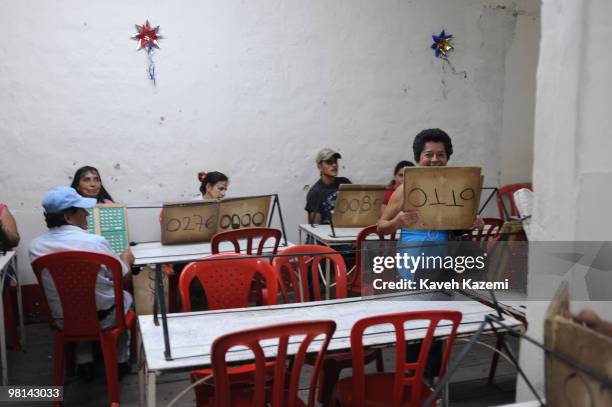 People busy playing a game of bingo in a hall at night in the city center. Quimbaya is a town and municipality in the western part of the department...