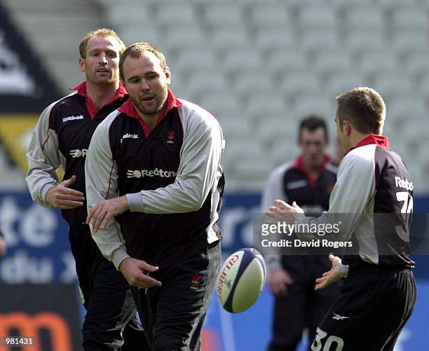Scott Quinnell the Welsh number 8, passes the ball to team mate Rhys Williams, during training at the Stade de France, Paris. Mandatory Credit: David...