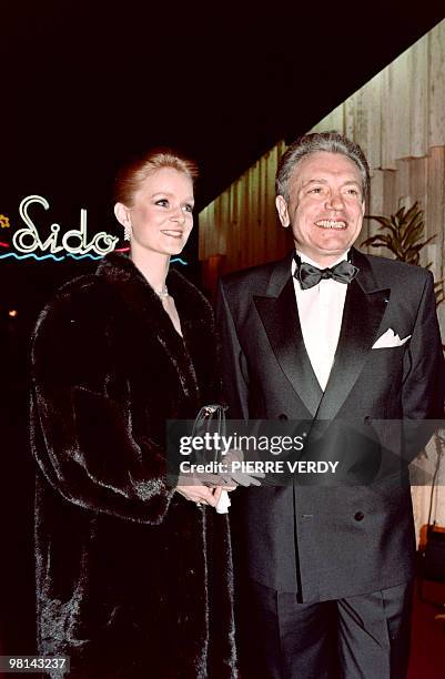 French television presenter Jacques Martin and his wife Celine Boisson attend the new revue of the Lido cabaret in Paris on March 14, 1990.