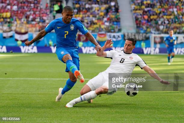 Douglas Costa of Brazil and Bryan Oviedo of Costa Rica battle for the ball during the 2018 FIFA World Cup Russia Group E match between Brazil and...