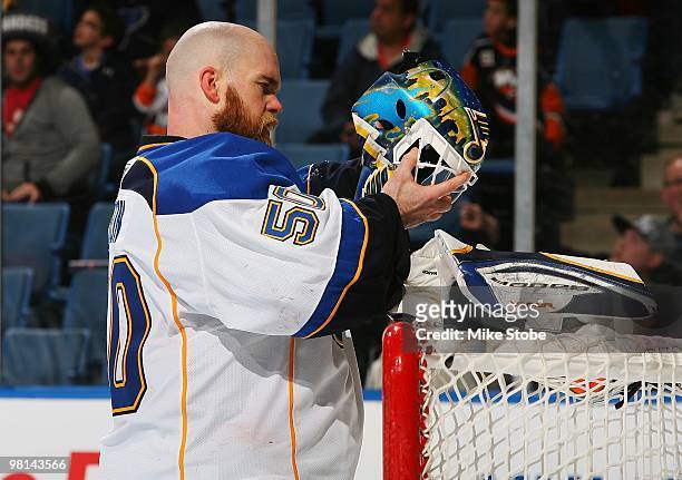 Chris Mason of the St. Louis Blues adjusts his face mask against the New York Islanders on March 11, 2010 at Nassau Coliseum in Uniondale, New York....